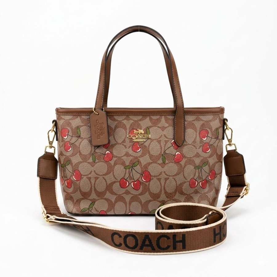 شنطة كتف وكروس مستوحاه من ماركة كوتش Coach مطبوعة مقاس وسط خامة بريميوم بحزام عريض | Demand & Beyond