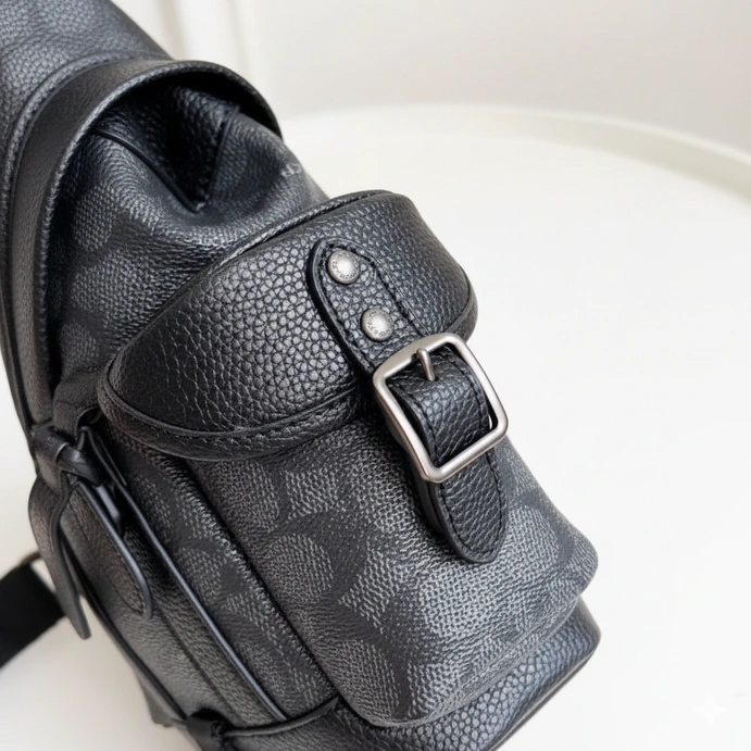 Redefine your daily commute with the Coach Signature Unisex Sling Bag #0057